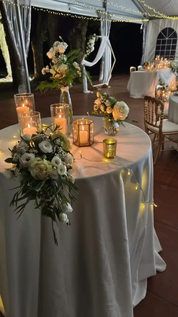 Table ronde, compositions de fleurs blanches et bougies